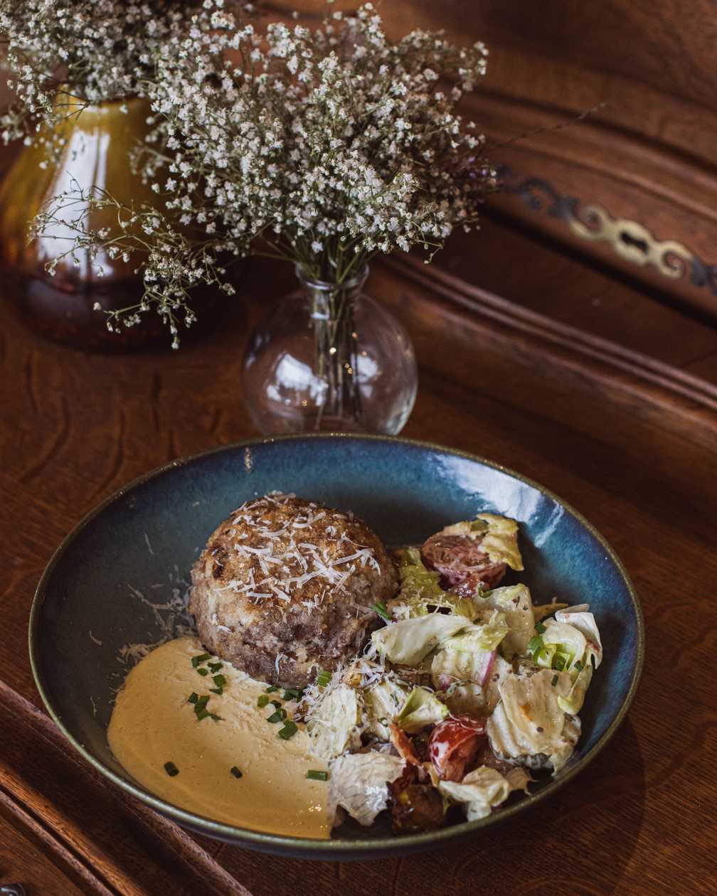 Homemade cutlet with roasted potato and bacon salad