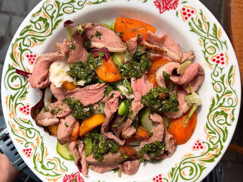 Duck salad with peaches and chimichurri sauce