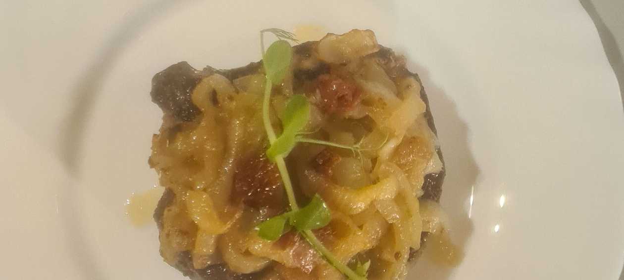 Pork Cutlet on the Bone with Caramelized Onions and Sun-Dried Tomatoes
