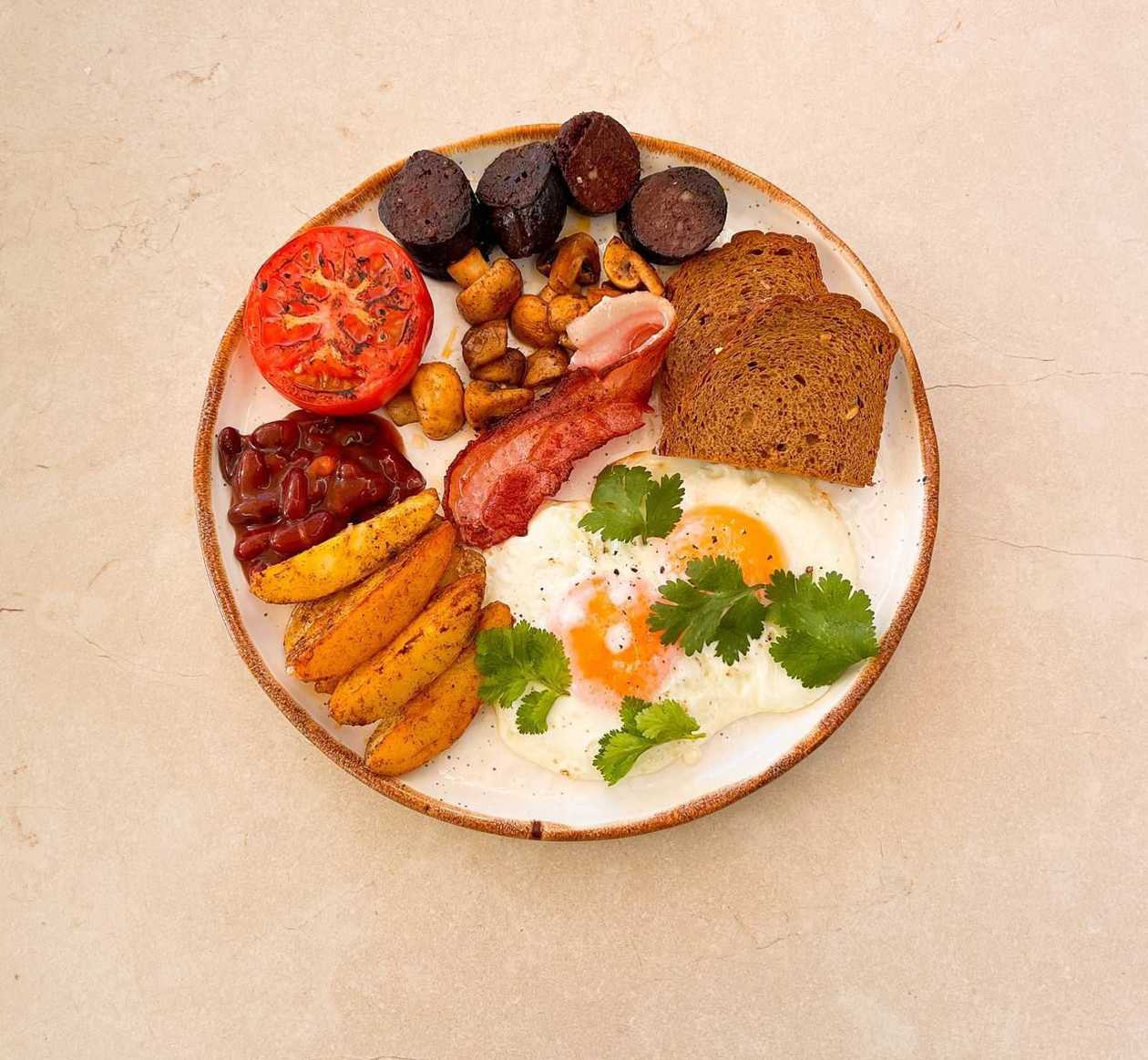 Fried Eggs with Bacon, Black Pudding, Beans in Tomato Sauce and Mushrooms