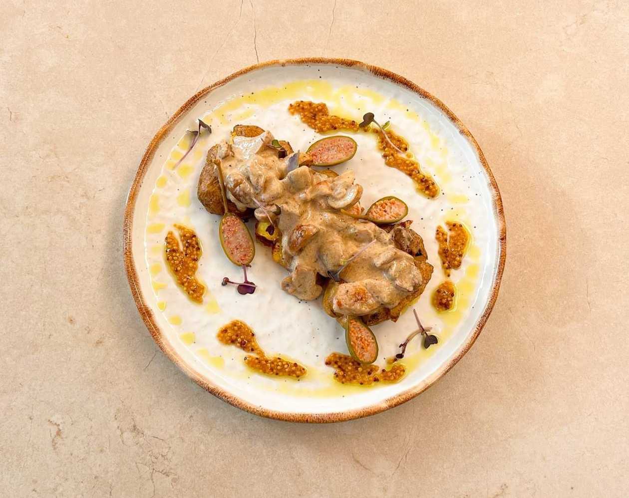 Baked potato with chicken and mushrooms in cream sauce