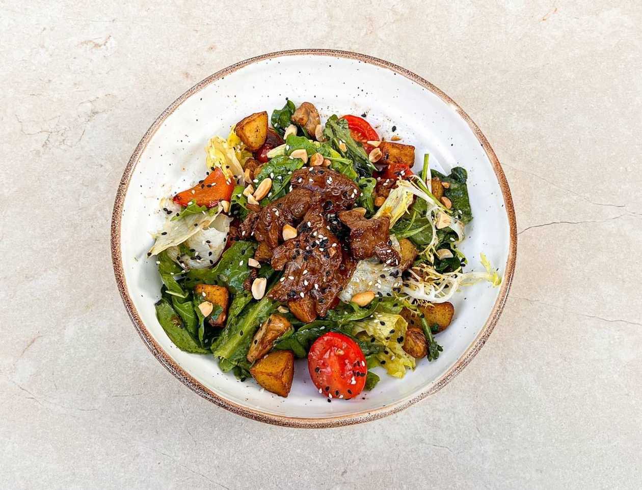 Warm salad with beef and grilled vegetables in truffle sauce