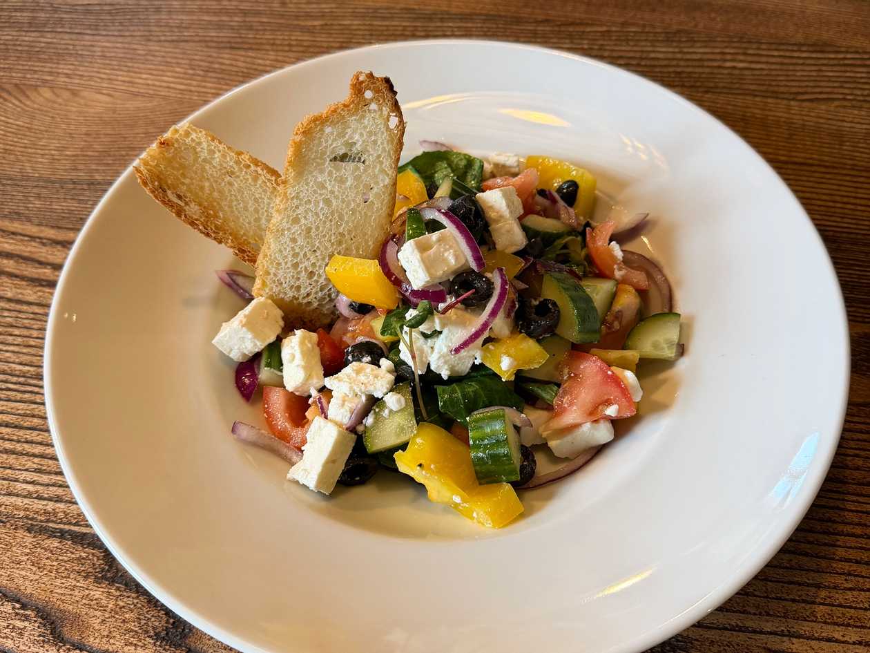 Greek salad with feta cheese (tomatoes, cucumbers, bell peppers, onions, black olives)