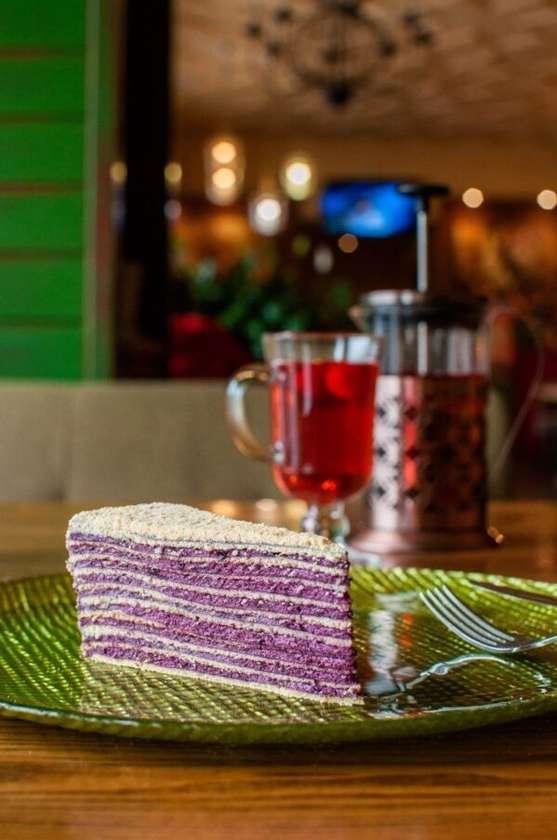 Homemade honey cake with blueberry cream