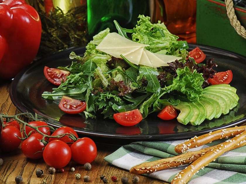 Green salad with avocado and Parmesan in Pesto sauce