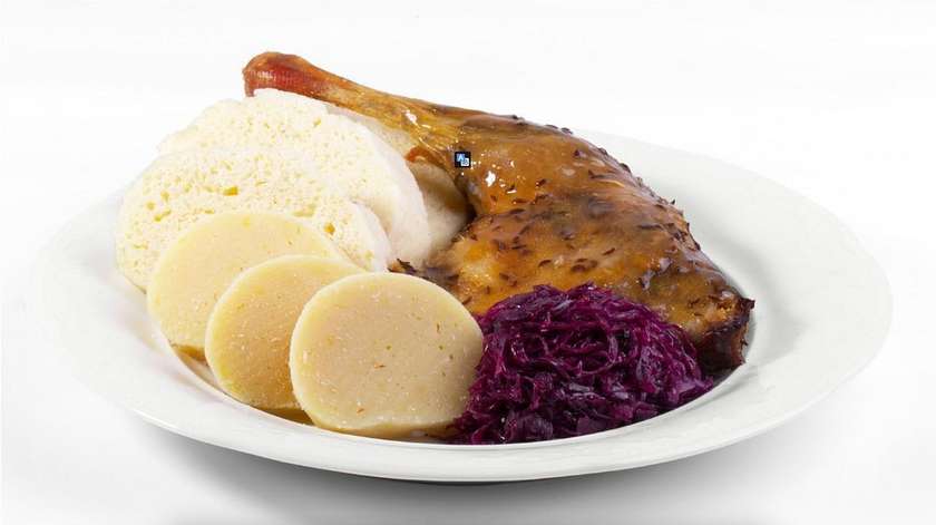 Roasted duck leg with red cabbage and a selection of dumplings