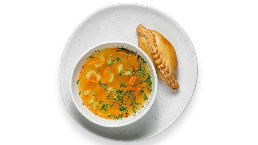 Homemade chicken broth with Kibinas stuffed with pork