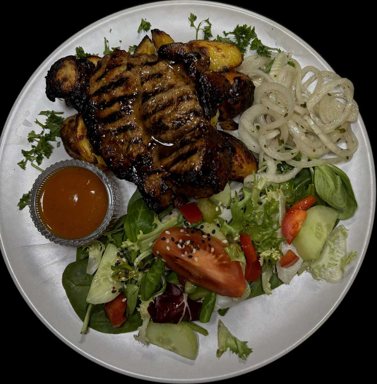 Spice-glazed pork with oven-roasted potatoes, pickled onions and Carolina-mustard sauce