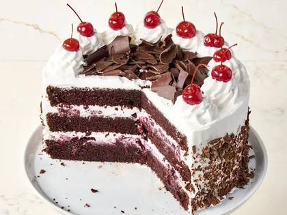 HOMEMADE CAKE WITH SOUR CHERRIES, THREE TYPES OF CHOCOLATE IN DIFFERENT TEXTURES AND CITRUS SAUCE