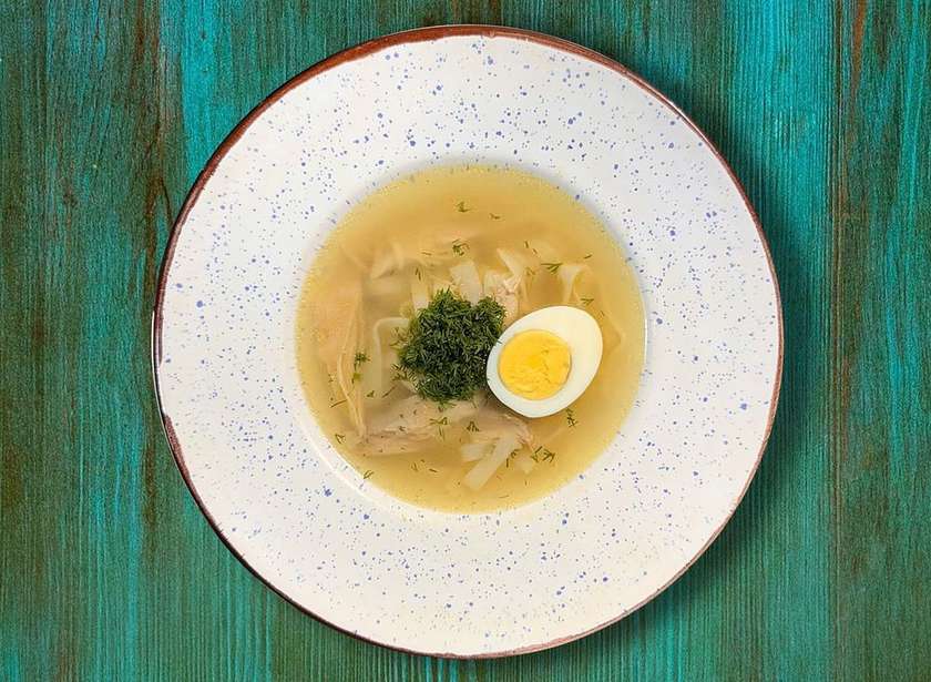 Chicken broth with homemade noobles and egg