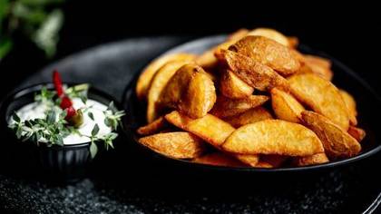 Skrudintos bulvių skiltelės su česnakiniu padažu