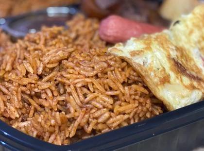 ⁠Jollof Rice with Sausage and Fried Eggs