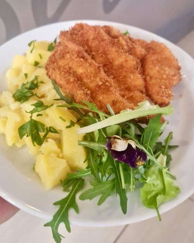 Fried pork cutlet, boiled potatoes, cucumber