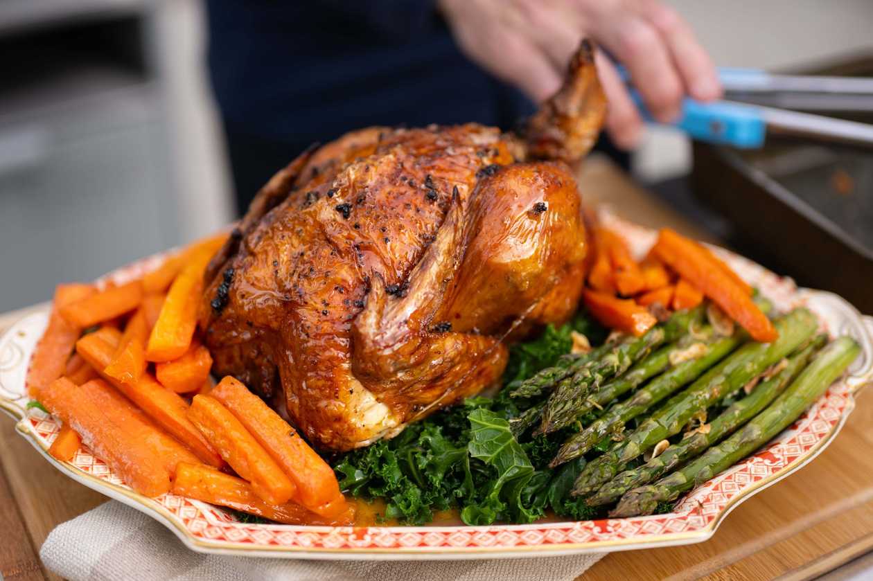 A whole mountain rooster in a cauldron served with dauphinoise au gratin potatoes