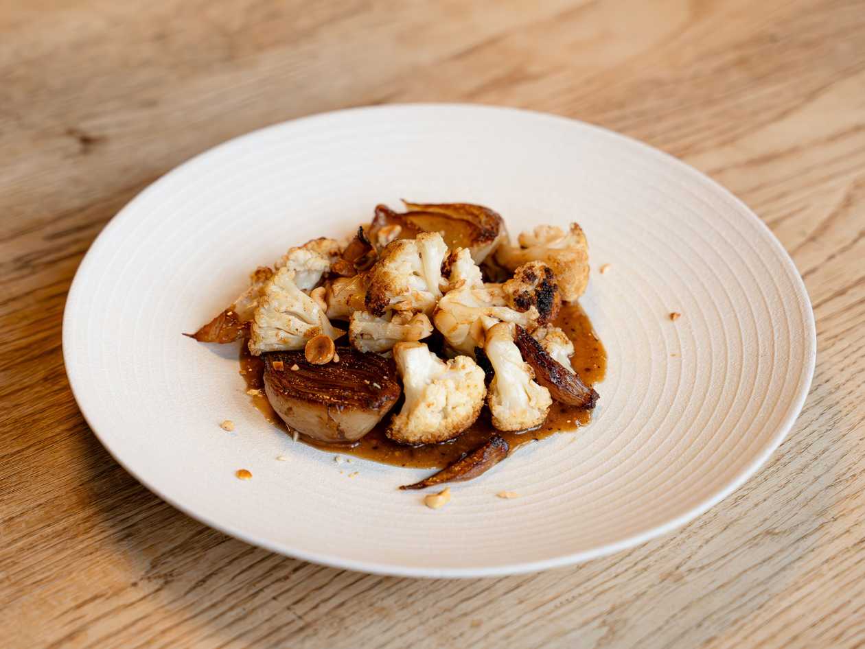 Baked cauliflower with caramelized onions and coffee vinaigrette