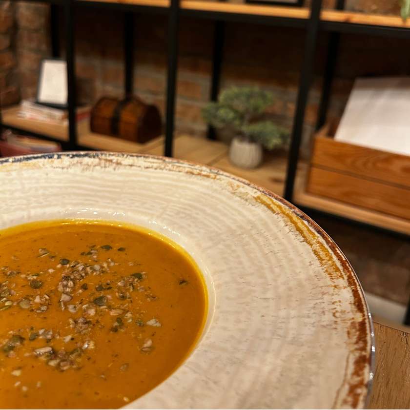 Pumpkin Cream Soup - served with rustic bread chips