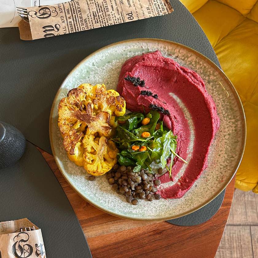 Cauliflower steak with bean Hummus - served with tomato sauce, lentils & salad