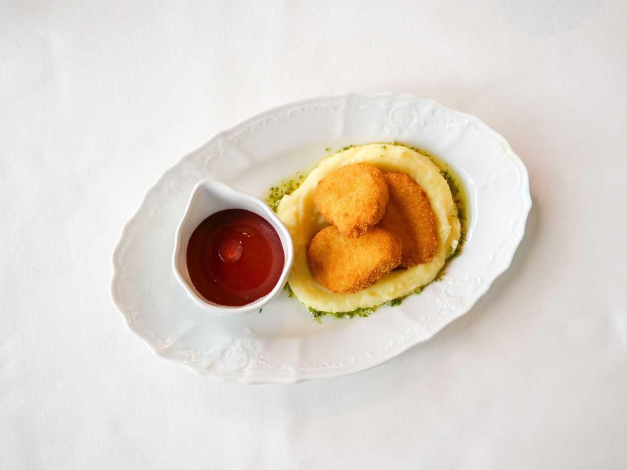 Картопляне пюре з курячими нагетсами та соусом