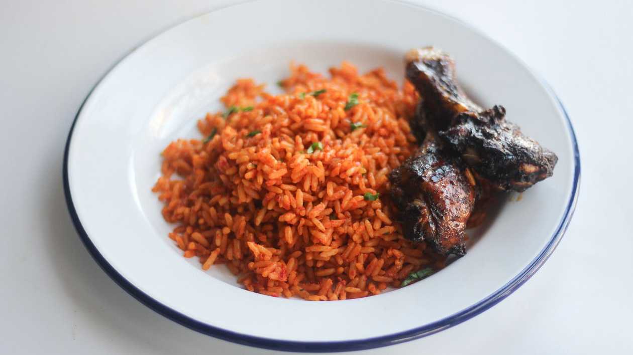 Jollof Rice with Grilled Chicken, coleslaw and kelewele.