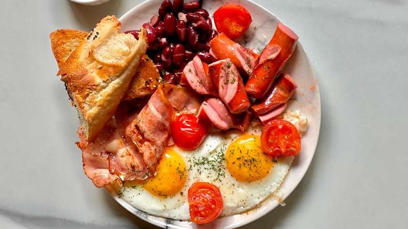 English breakfast with eggs, bacon, sausages and beans
