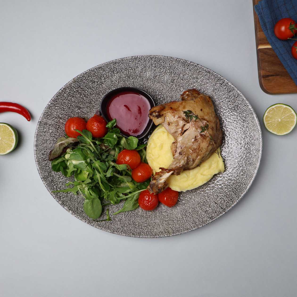 Slow cooked duck leg with mashed potatoes and cranberry - apple sauce