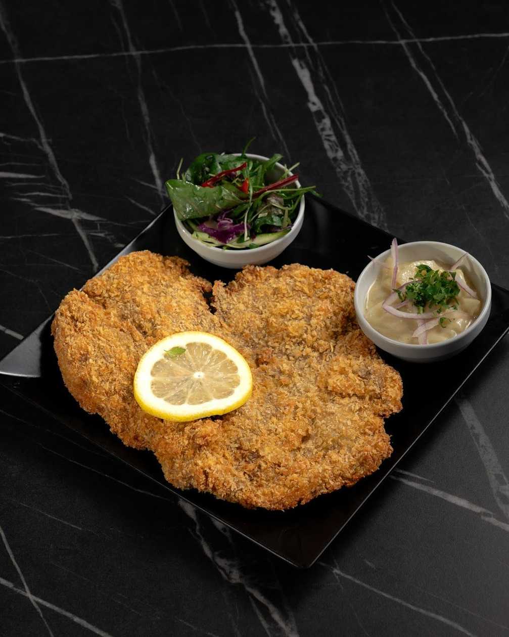 Veal schnitzel served with potato salad