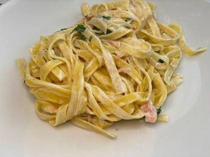 Tagliatelle with Salmon in White Wine with Cream, Garlic and Philadelphia Cheese, sprinkled with Parmesan