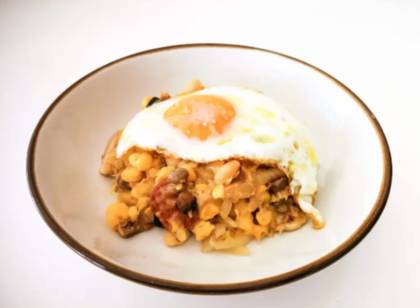 Sautéed Cachupa with Sausage and Fried Egg
