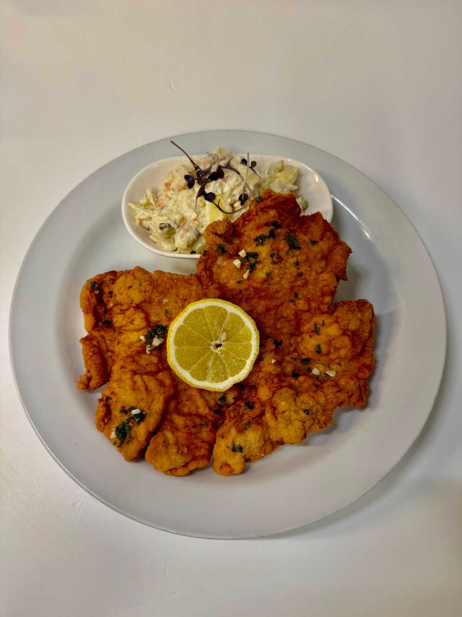NEW - XL Schnitzel (pork) with chive butter and garlic, our potato salad -