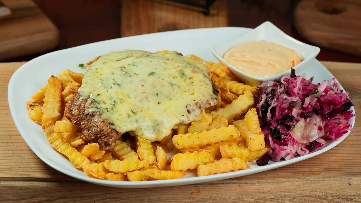 Pork chop with cheese and side dish