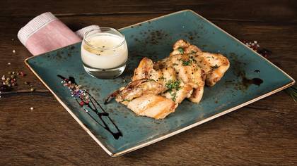 Juicy chicken thighs with pepper sauce