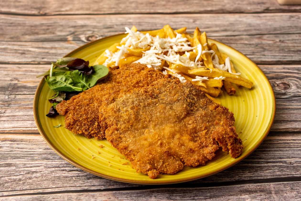 Turkey Breast Schnitzel in Panko served with French Fries and Grated Cheese