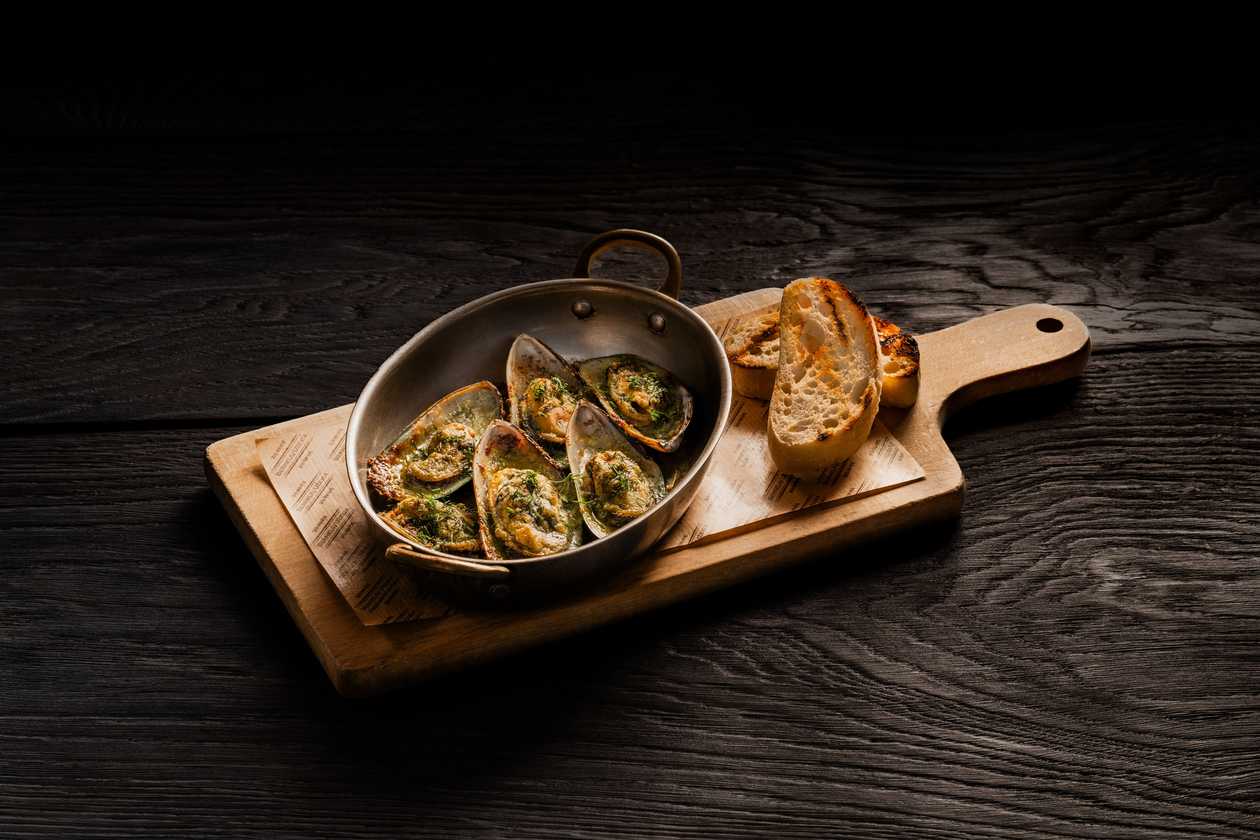 Mussels baked in a charcoal oven with garlic herb butter and "Džiugas" cheese