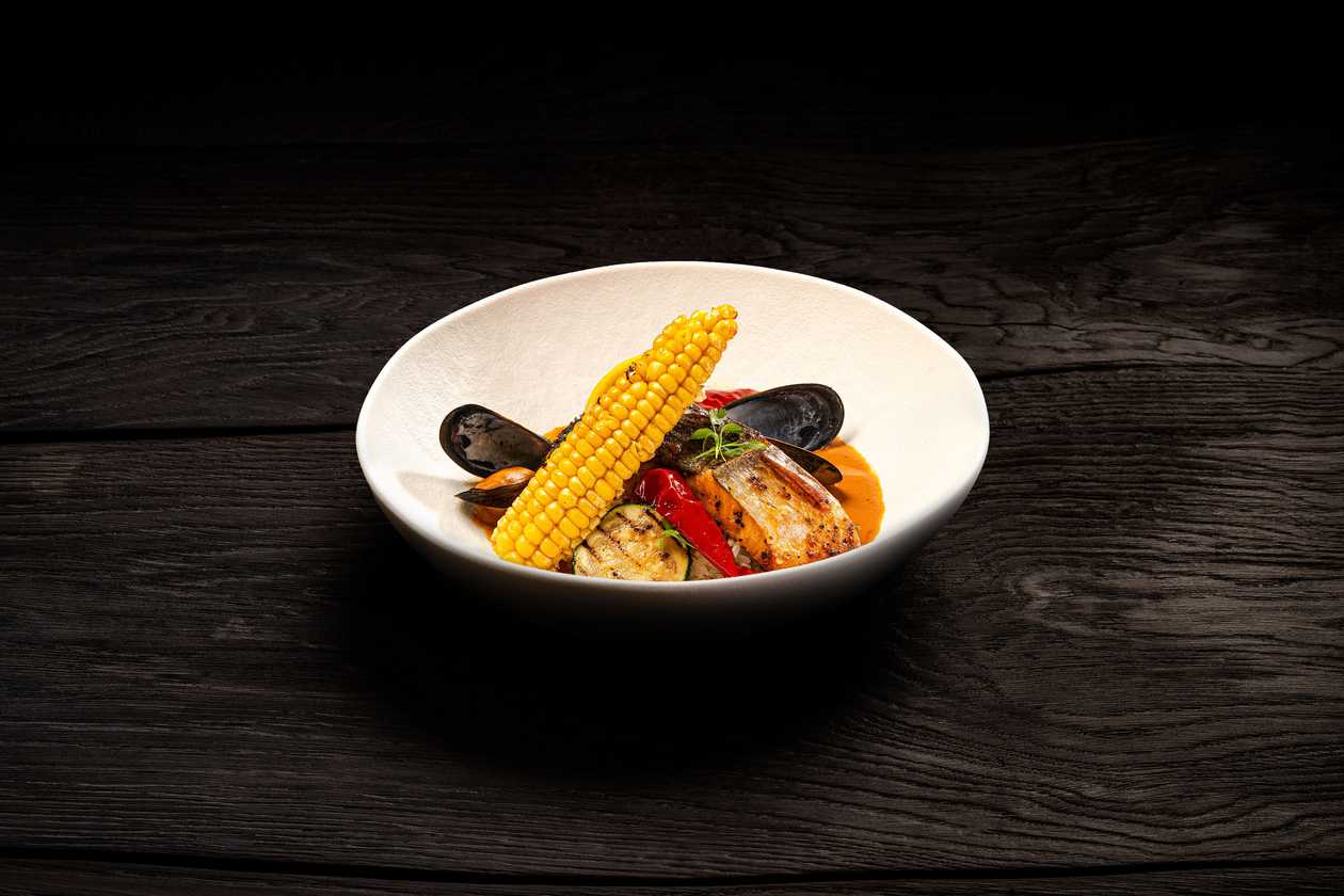 Salmon fillet steak with mussels in a crushed tomato and cream sauce