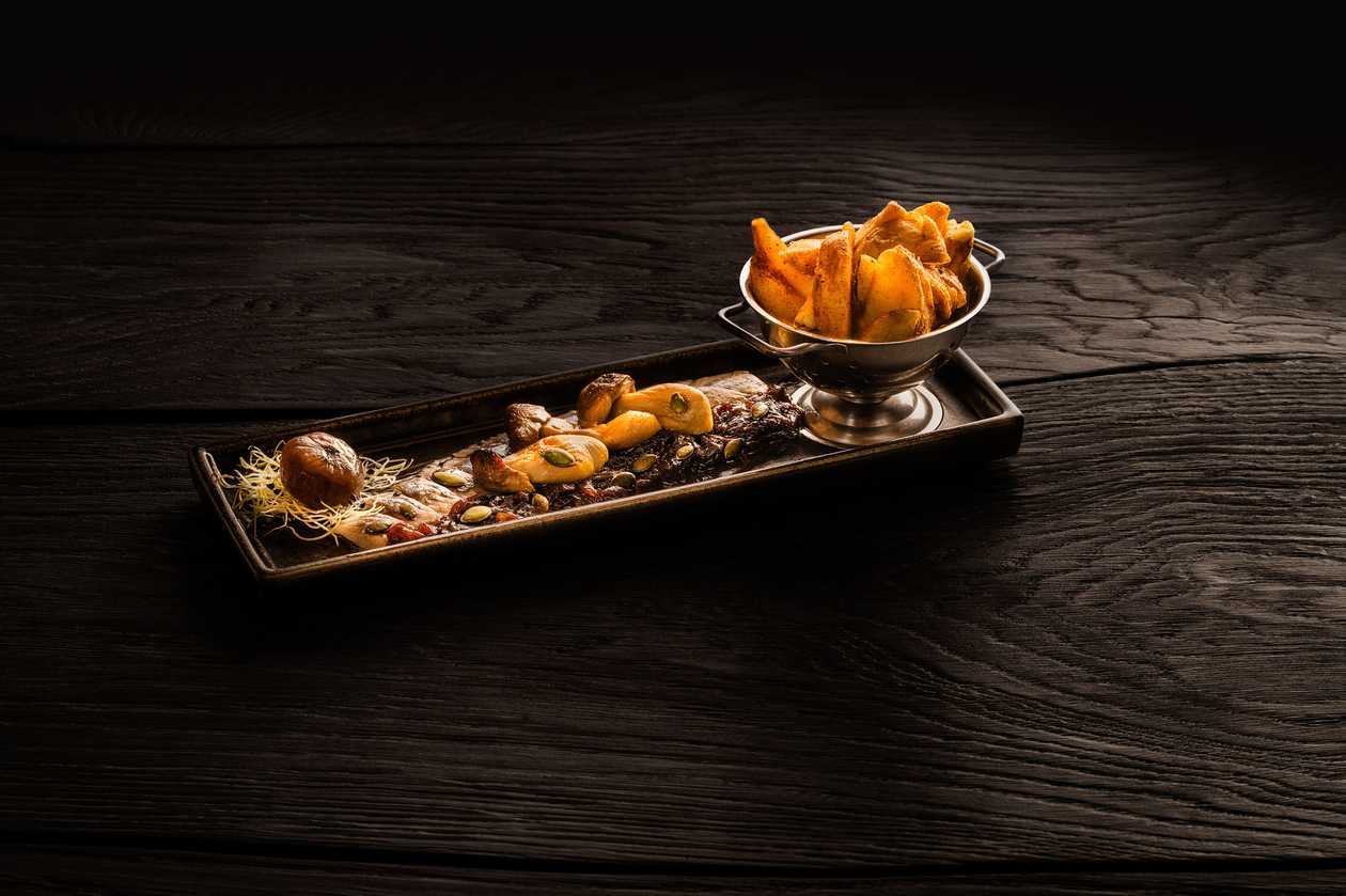 Herring fillet with fried boletus mushrooms, caramelized onions and pumpkin seeds