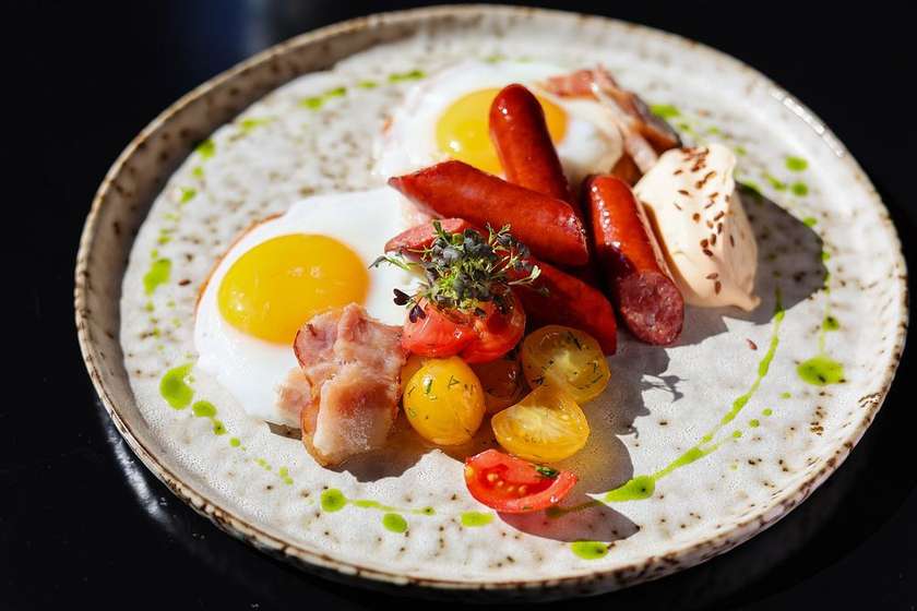 Деруни з ковбасками, беконом та яєчнею