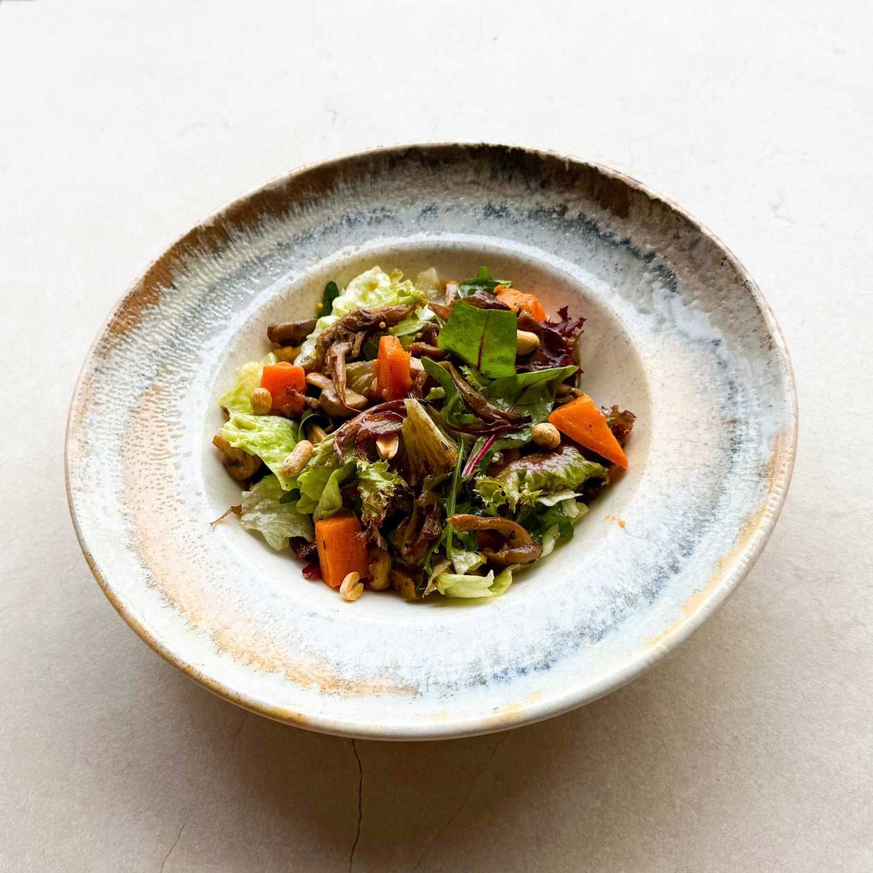 Warm salad with sweet potato, mushrooms and vegetables in mustard sauce