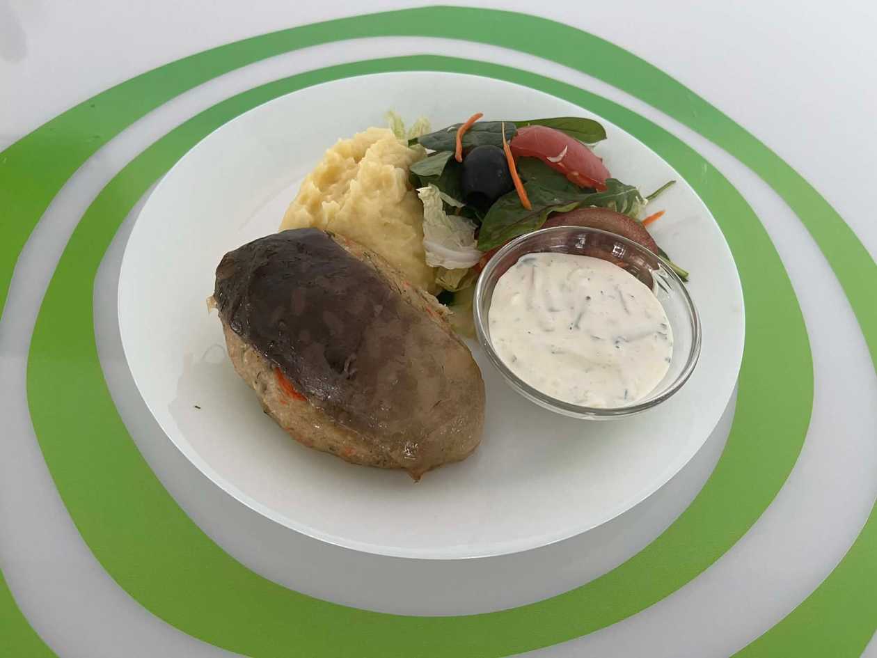 Carp patty with tartar sauce, mashed potatoes and vegetables