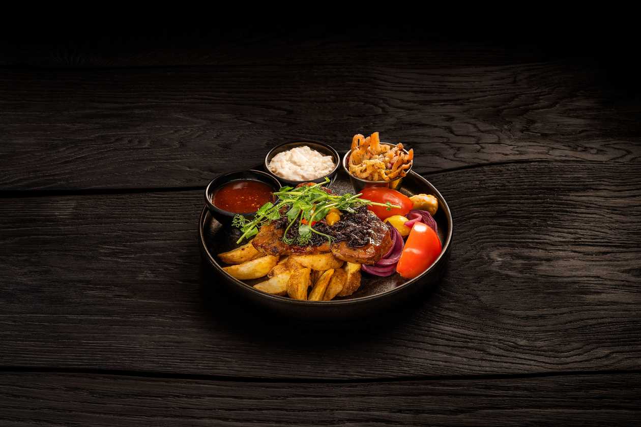 Pork neck steak with caramelized onions