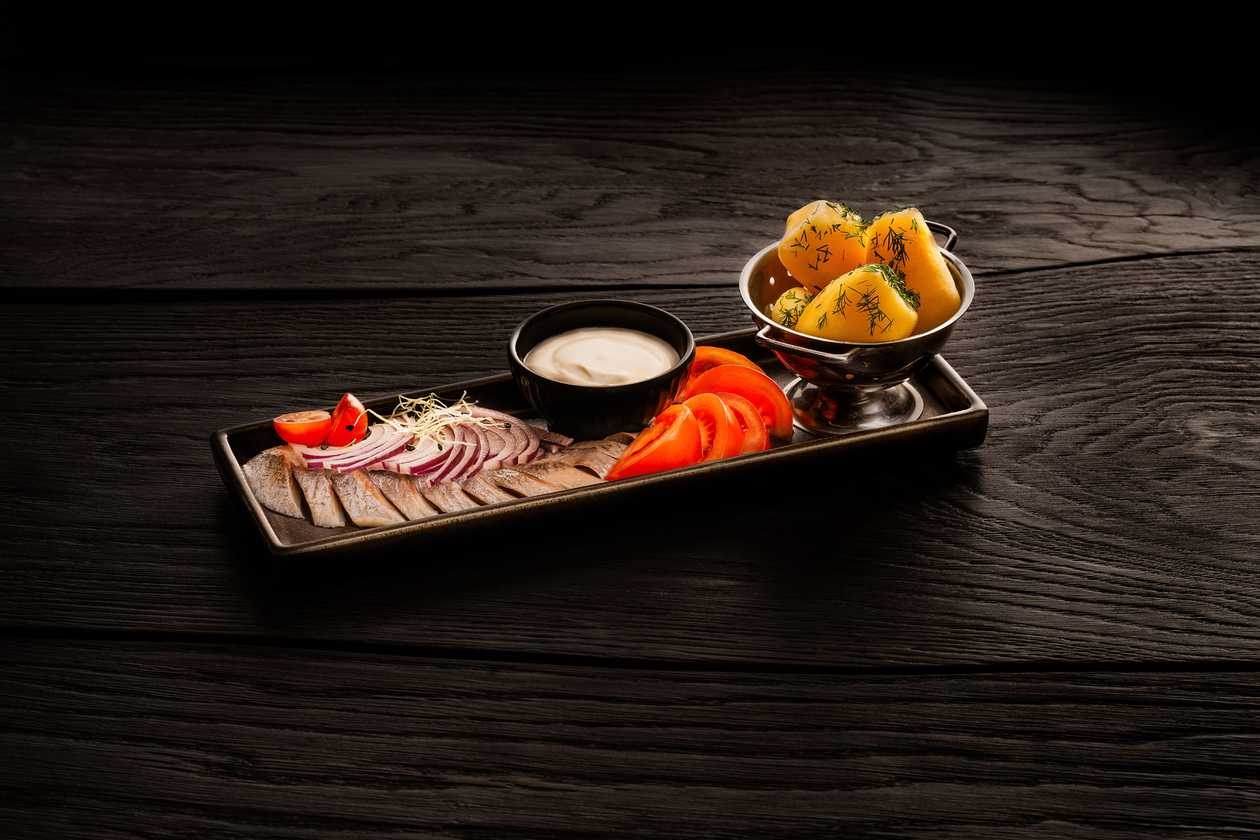 Rustically prepared herring snack with warm potatoes