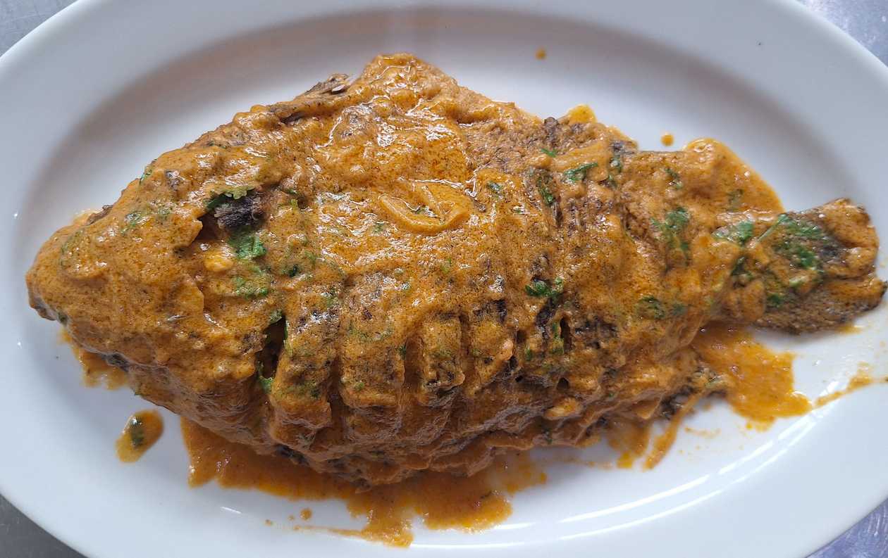 Fish Tilapia whole in coconut sauce.