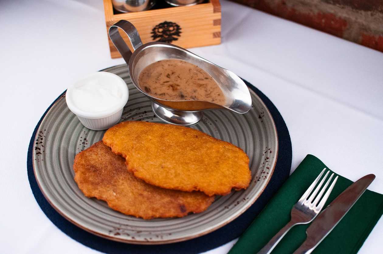 Potato pancakes served with mushroom sauce & sour cream