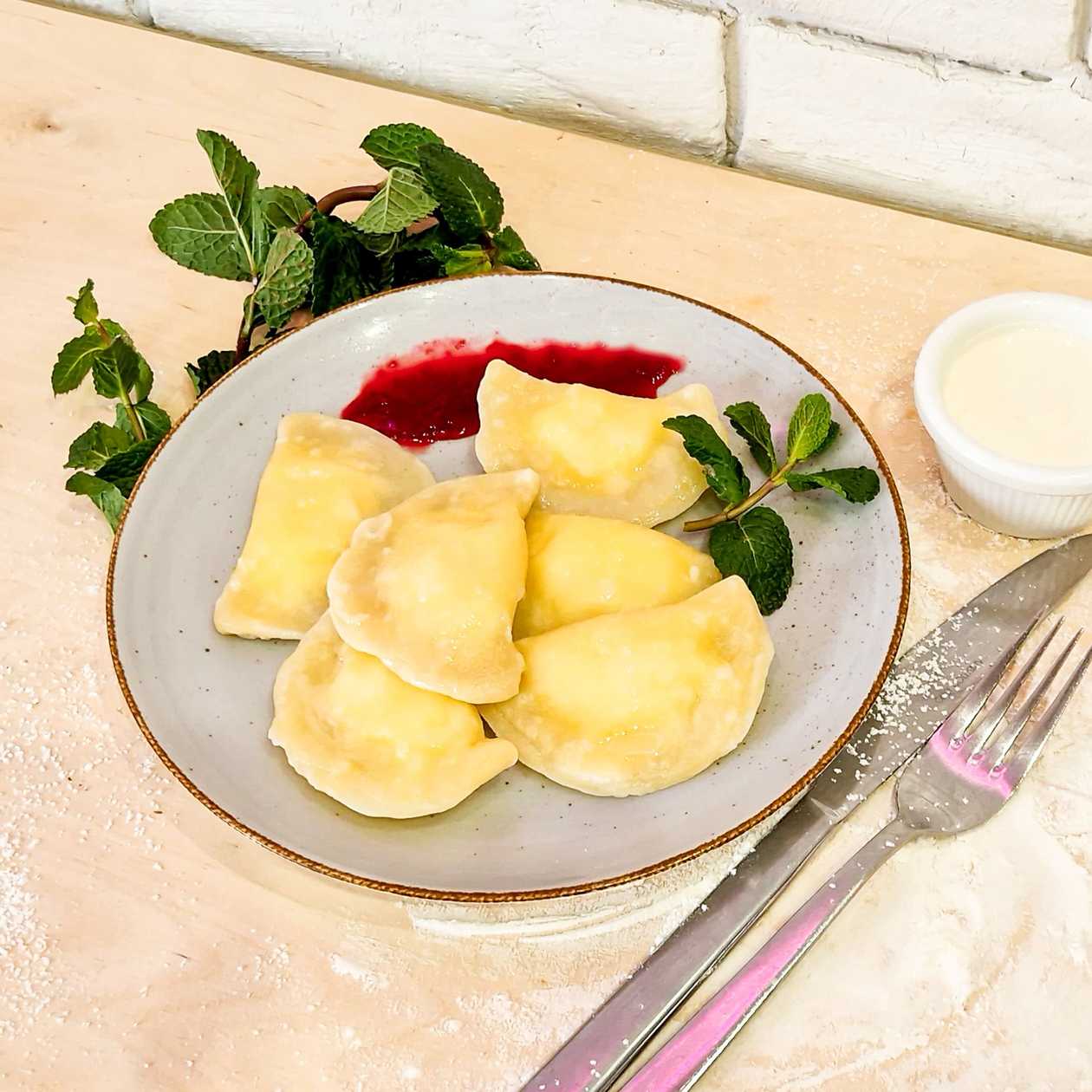 Pierogi with sweet cottage cheese served with sour cream and raspberry sauce 6pcs