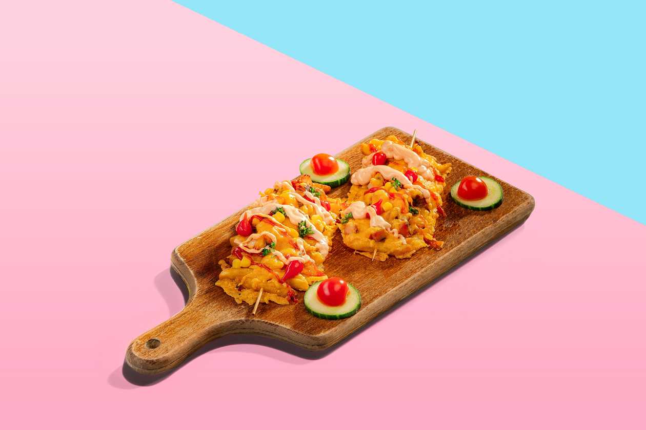 Skewers of fried potatoes with grilled chicken fillet and cheddar cheese