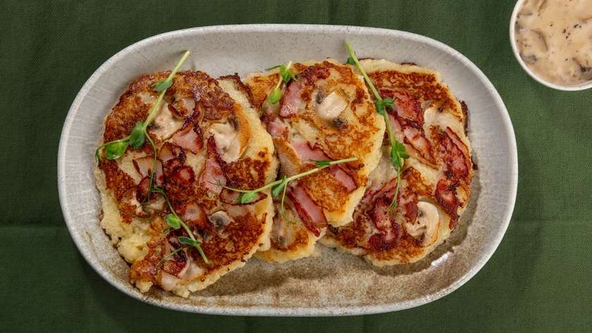 Potato pancakes fried with bacon and mushrooms