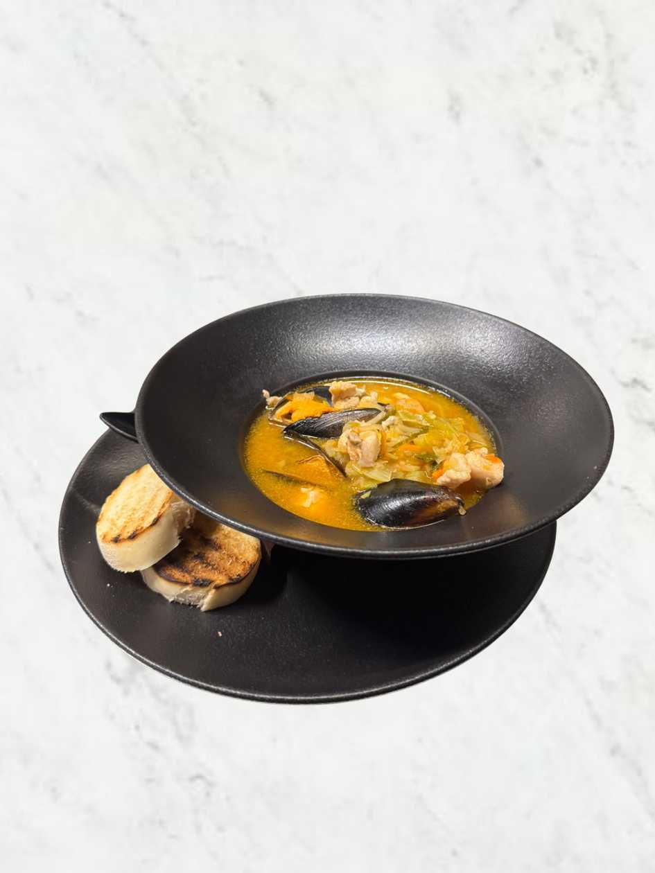 Bouillabaisse fish soup with garlic bread and paprika aioli