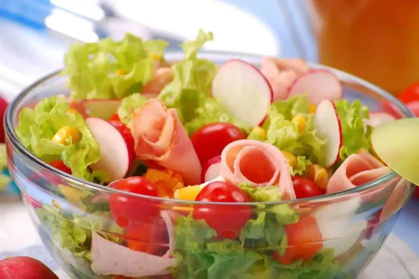 Salad with Tomatoes, Cucumbers, Eggs, Ham, and Lettuce