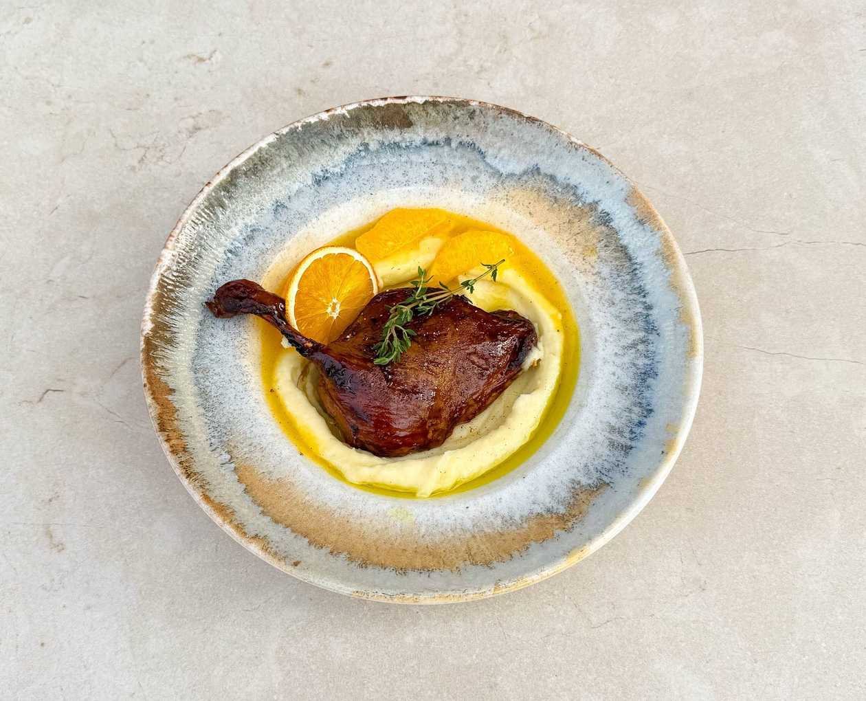 Duck leg with mashed potatoes and orange sauce