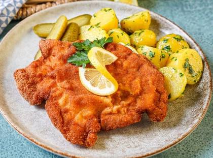 Coated slices of pork tenderloin + potatoes + pickles