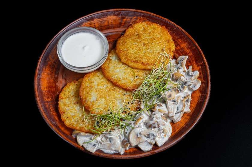 Potato pancakes with mushrooms in creamy sauce